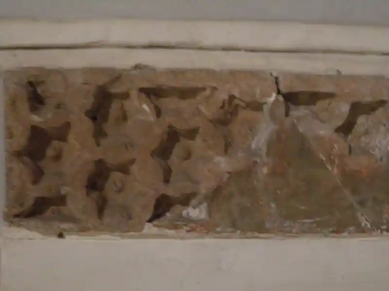 Six-pointed symbol resembling the sun engraved on a clay